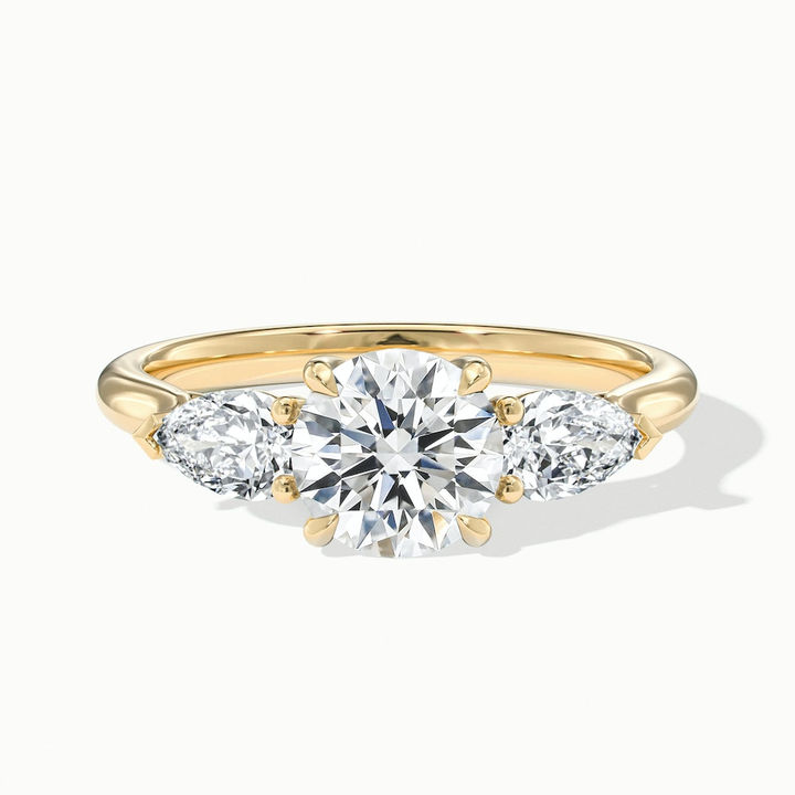 Amaya 5 Carat Round 3 Stone Moissanite Diamond Ring With Pear Side Stone in 14k Yellow Gold